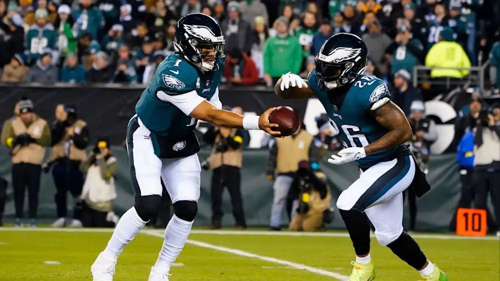 Miles Sanders taking handoff from Jalen Hurts Eagles
