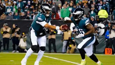 Miles Sanders taking handoff from Jalen Hurts Eagles