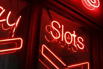 A neon red sign spelling out the word Slots